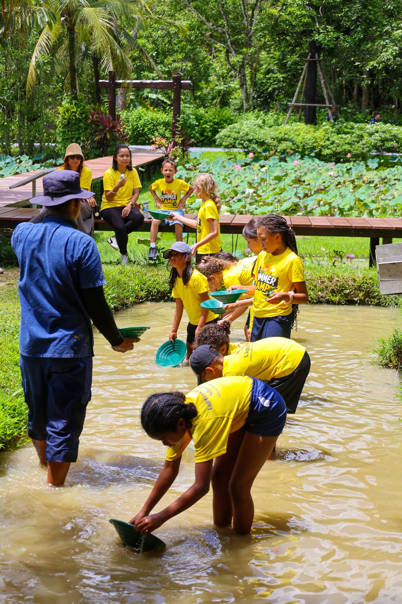 Farmer teaching Lighthouse Phuket students to farm