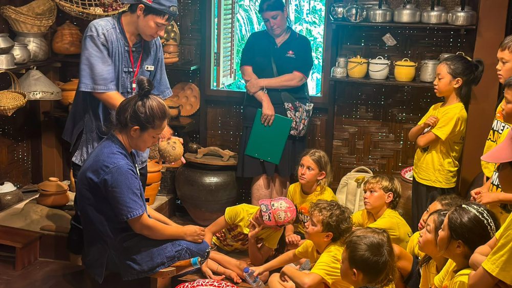 Farmers teaching Lighthouse Phuket students to about planting rice