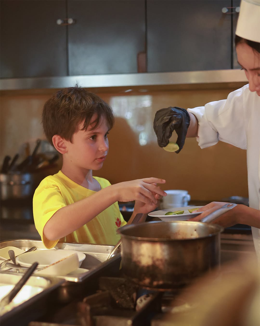 Little boy listening to the professional chef Little boy listening to the professional chef