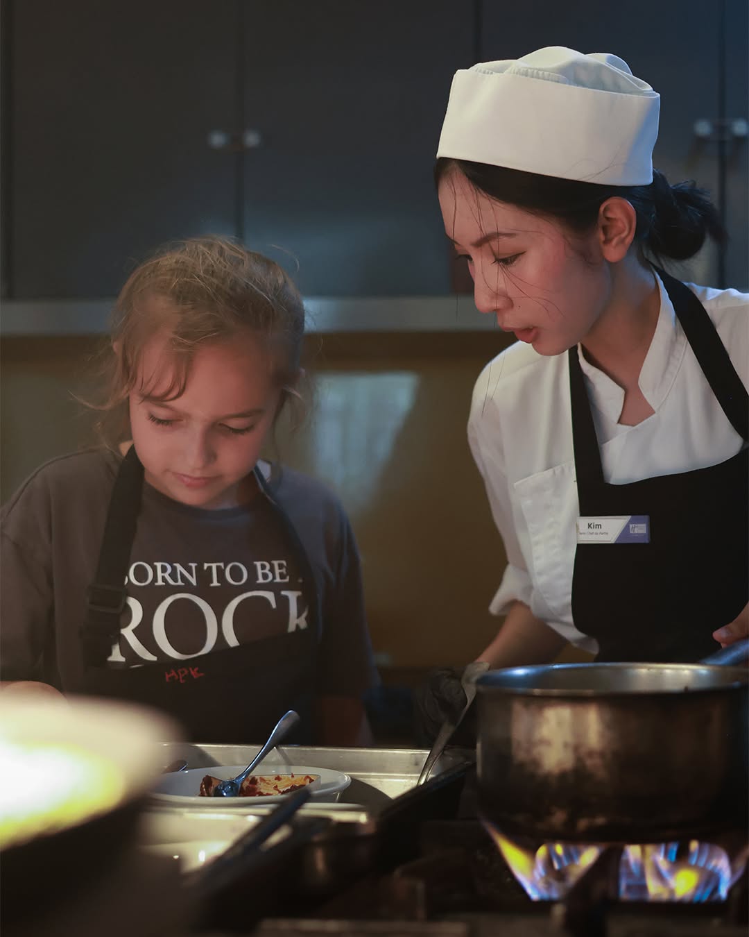 Student and professional chef collaborating Student and professional chef collaborating