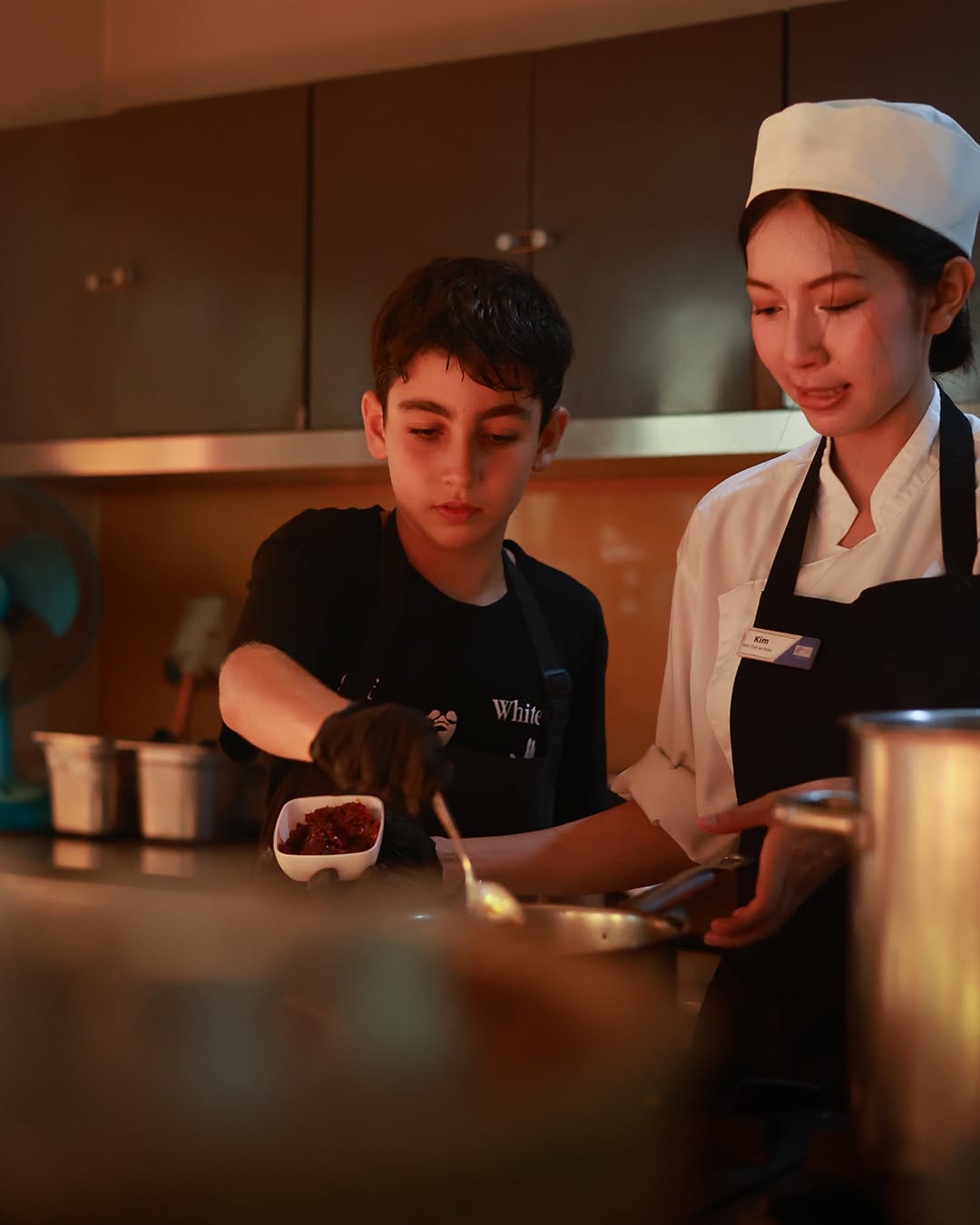 Student cooking with a professional chef Student cooking with a professional chef