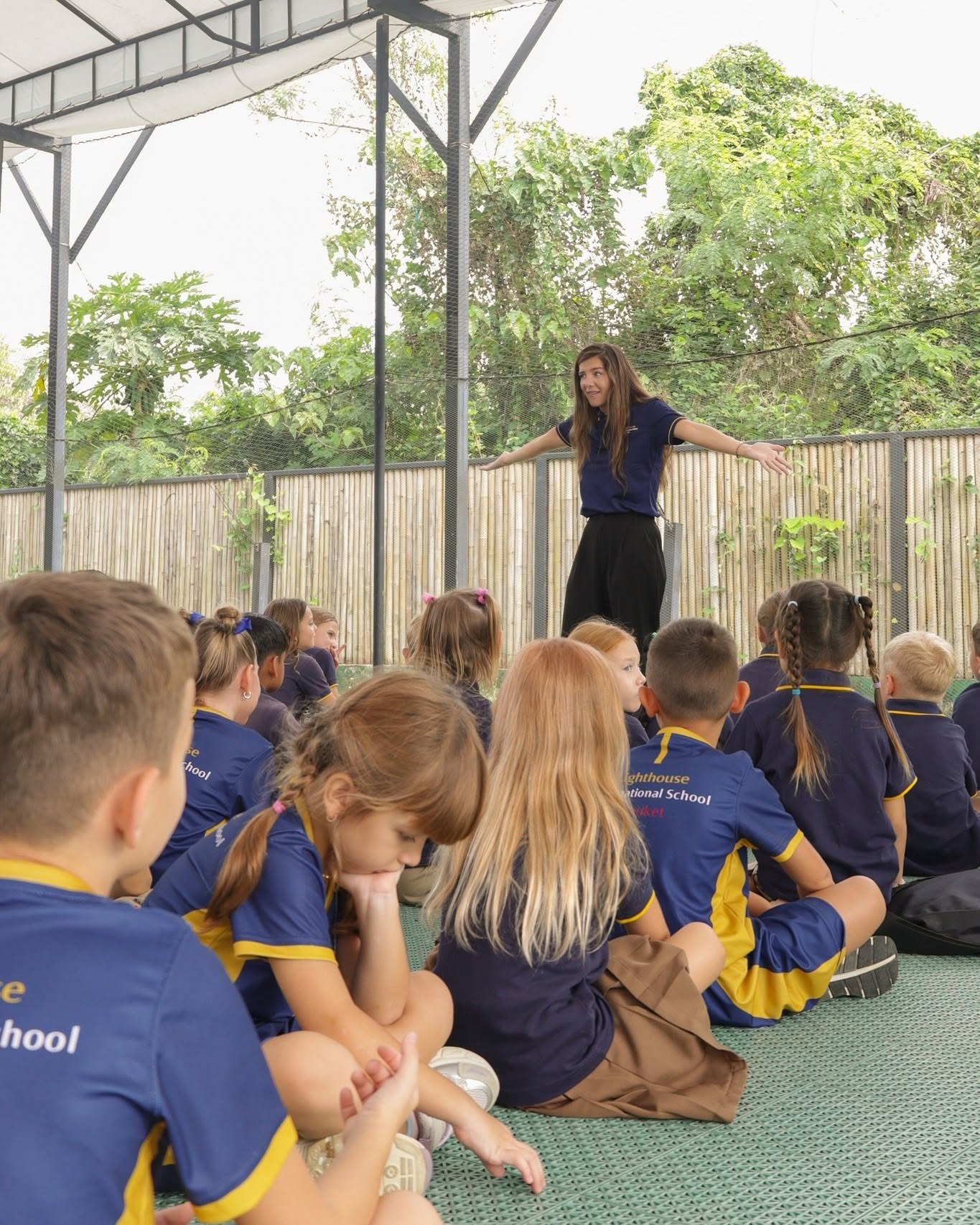 Teacher with primary students of Lighthouse International School