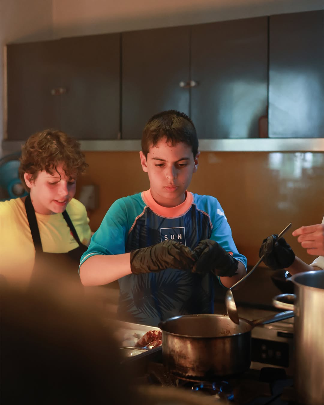 Two boys cooking with professional chef - Lighthouse Masterchef Two boys cooking with professional chef - Lighthouse Masterchef