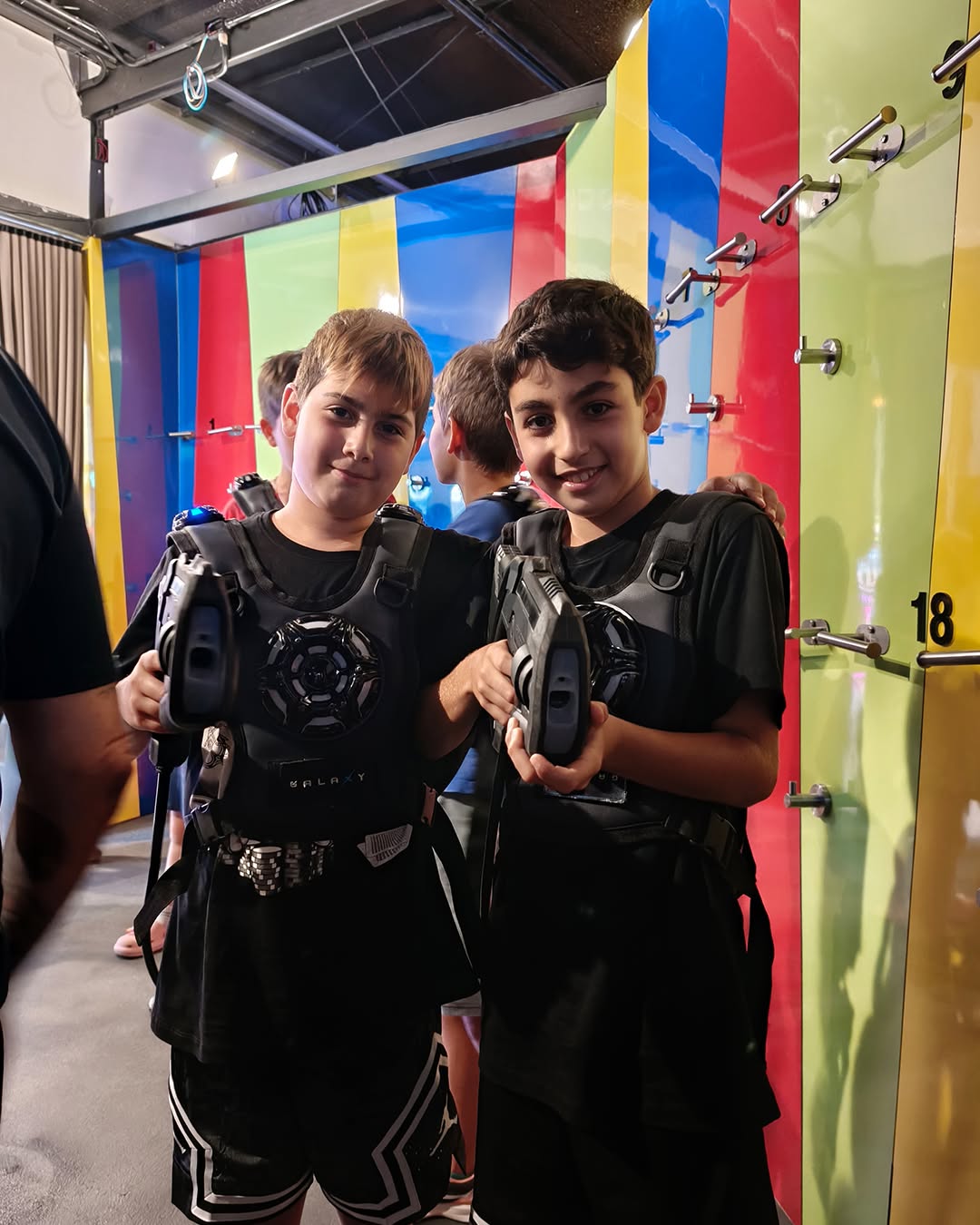 Two students posing with laser tag equipment