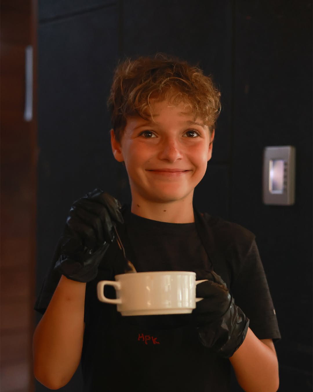 boy smiling while holding kitchenware boy smiling while holding kitchenware